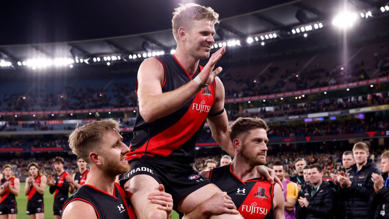 MELBOURNE, AUSTRALIA - AUGUST 20: Michael Hurley of the Bombers is chaired from the ground after the round 23 AFL match between the Essendon Bombers and the Richmond Tigers at Melbourne Cricket Ground on August 20, 2022 in Melbourne, Australia. (Photo by Darrian Traynor/Getty Images)