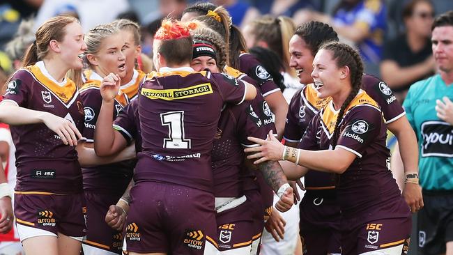 Rona Peters celebrates with teammates after scoring a try for the Broncos. Picture: Getty Images