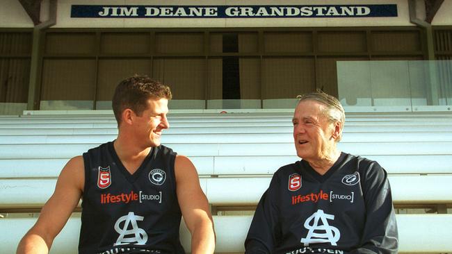 Jim Deane with former South Adelaide and Crows player Clay Sampson sitting in the Jim Deane Grandstand at Noarlunga Oval in Jun 2003.