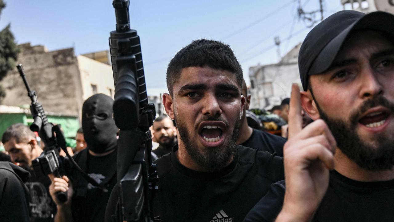 Armed Palestinians take part in the funeral of three men killed during an overnight raid by the Israeli army into the Jenin refugee camp. Picture: AFP