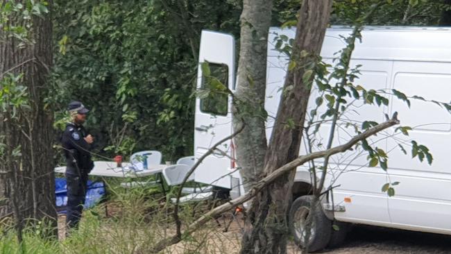 HUNT: Police guard Burns Rd at Ross Creek near Gympie where detectives are scouring for clues after the body of a man was found in ditch on a property. Photo: Frances Klein