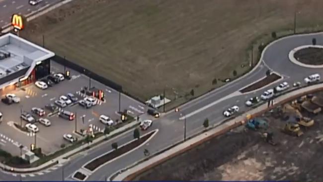 Police, right, were stopping cars in Pimpama Thursday evening. It's not been confirmed if it was to do with the manhunt of Zlatko Sikorsky. Picture: 7 News