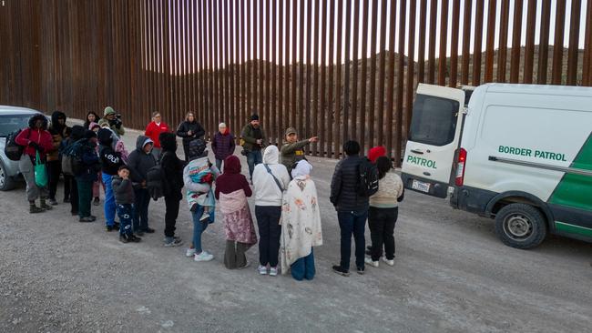 Immigrants wait to be transported by US Border Patrol agents after crossing the border. Picture: Getty Images via AFP.