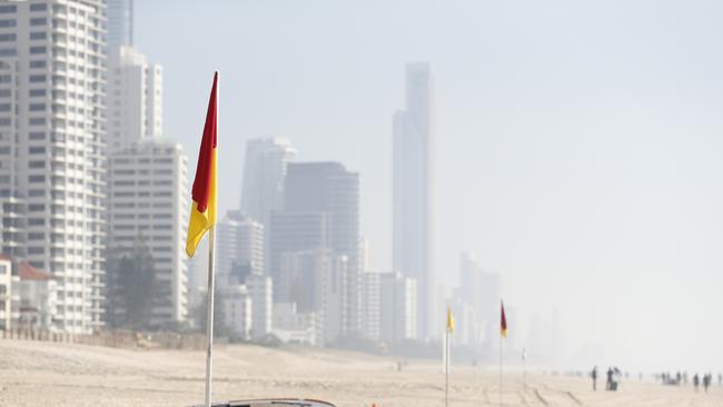 Smoke haze from bushfires obscures the skyline on the beach at Surfers Paradise in September last year. Picture: AAP Image/Tim Marsden