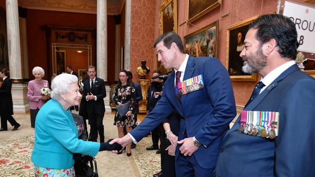 Queen Elizabeth II shakes hands with Roberts-Smith during a reception for the Victoria Cross and George Cross Association in 2018.