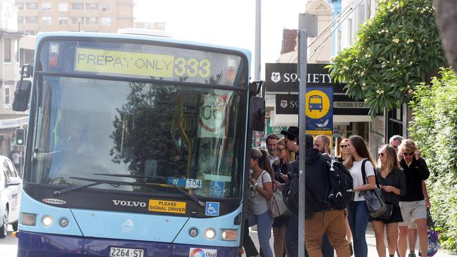 Commuters pile onto a bus on Bondi Rd on Tuesday morning. Picture: Craig Wilson