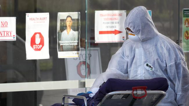 MELBOURNE, AUSTRALIA - NewsWire Photos JULY 30, 2020: A medical worker takes a trolley into Epping Gardens Aged Care home which has a COVID-19 breakout. Picture: NCA NewsWire /David Crosling