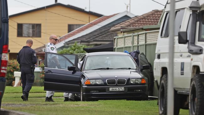 Police searching a car near where a man was arrested at Windang on the NSW south coast. Picture: Richard Dobson