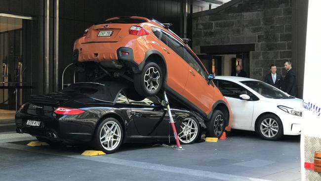 An orange 4WD is pictured atop a crushed Porsche at the Hyatt Regency in Sydney's CBD after an accident this week. Picture: Chris Harris