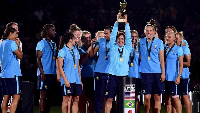 Matildas forward Lisa De Vanna lifts the Tournament of Nations trophy.