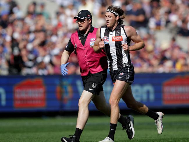 MELBOURNE, AUSTRALIA - SEPTEMBER 30: Nathan Murphy of the Magpies leaves the ground in the hands of a trainer during the 2023 AFL Grand Final match between the Collingwood Magpies and the Brisbane Lions at the Melbourne Cricket Ground on September 30, 2023 in Melbourne, Australia. (Photo by Russell Freeman/AFL Photos via Getty Images)