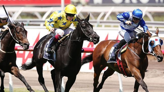 Dear Demi makes ground late on winner Side Glance (centre) in the Mackinnon Stakes on Derby Day. Picture: Getty Images