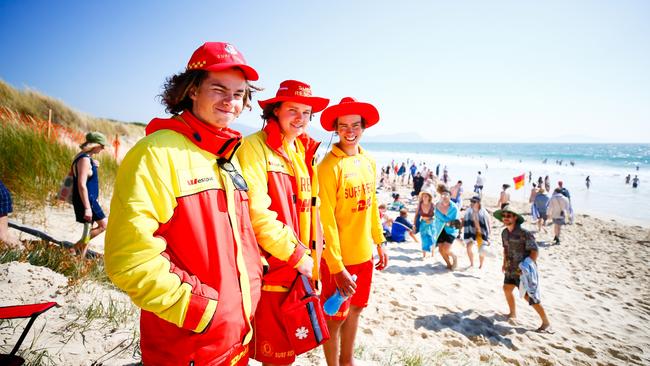 Surf live savers, from left, Oliver Lohrey, Thomas Bent and Kieren Black keep an eye on the thousands of Falls Festival punters on Marion Bay Beach. Picture: PATRICK GEE