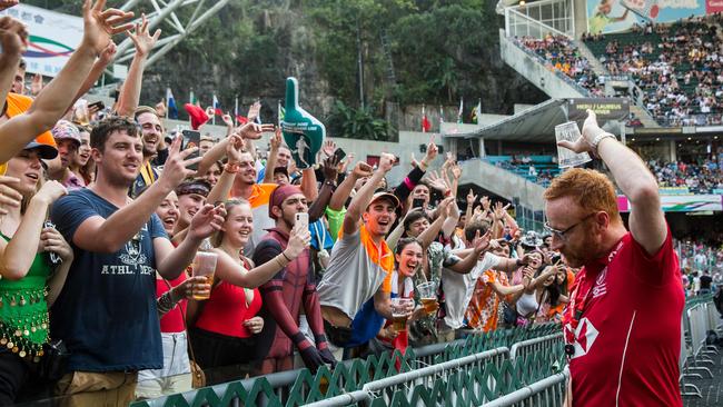 Ben Ryan, ex-Fiji Sevens coach, sculling a beer in front of fans in the south stand on the second day of the Hong Kong Sevens rugby tournament. Picture: Isaac Lawrence/AFP