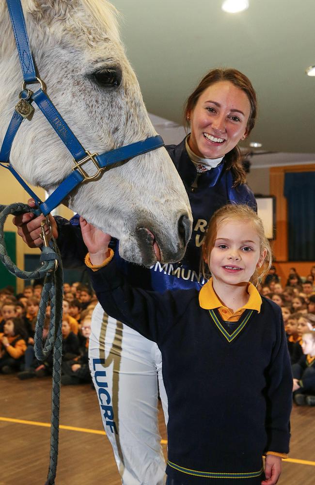 Subbie — as he is affectionately known — with prep student Evie and racing personality Katelyn Mallyon during a visit to St Raphaels Primary School.