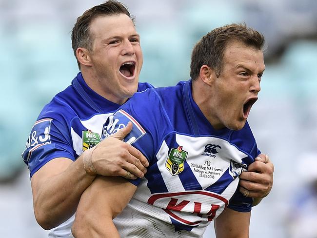 Josh Morris (right) celebrates with brother Brett (left) after scoring a try.