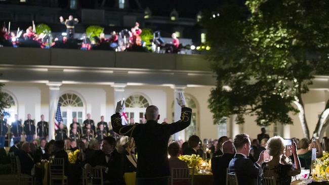 Guests listen to music in the Rose Garden of the White House during a State Dinner with President Donald Trump and first lady Melania Trump for Australian Prime Minister Scott Morrison and his wife Jenny Morrison at the White House. Picture: AP