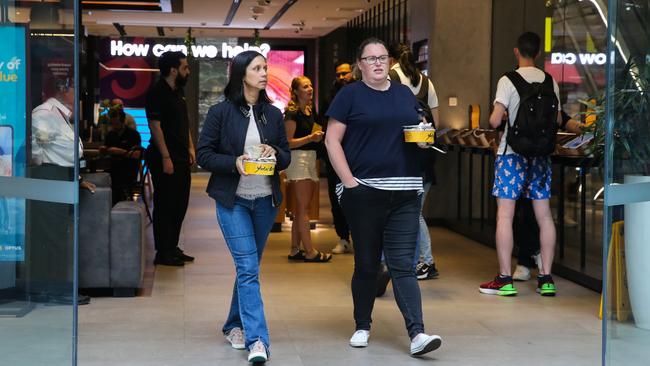 Customers leaving an Optus store in the Sydney CBD on George St on Wednesday. Picture: NCA Newswire /Gaye Gerard