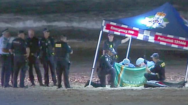 Police at the scene where a baby’s body was found on a Gold Coast beach — Photo Supplied CH 7