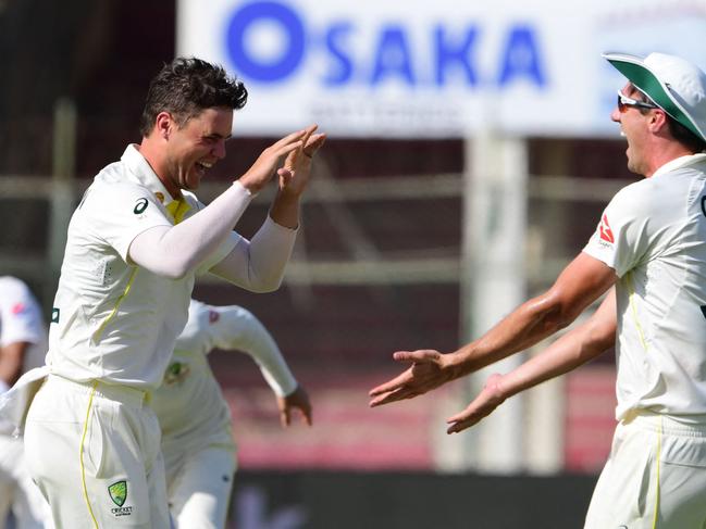 Mitch Swepson (left) celebrates one of his two Test wickets in Pakistan. Picture: ASIF Hassan / AFP