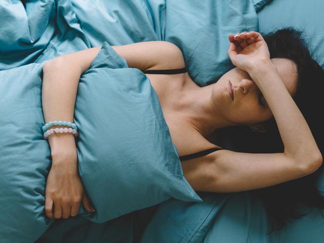 Depressed woman in bed with hand on forehead  Picture: istock