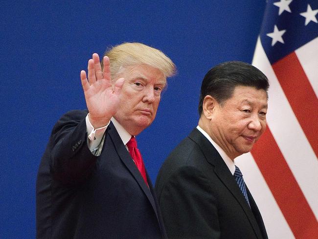 (FILES) In this file photo US President Donald Trump (L) and China's President Xi Jinping leave a business leaders event at the Great Hall of the People in Beijing on November 9, 2017. - Donald Trump pleaded with China's leader Xi Jinping for help to win re-election in 2020, the US president's former aide John Bolton writes in an explosive new book, according to excerpts published June 17. (Photo by Nicolas ASFOURI / AFP)