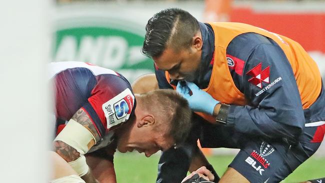 Sean McMahon of the Rebels leaves the field injured at AAMI Park.