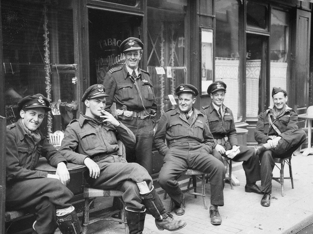 D-Day feature, June 2024 BAYEUX, FRANCE. C. 1944-07. INFORMAL GROUP OF SPITFIRE PILOTS OF NO. 453 SQUADRON RAAF, OUTSIDE A CAFE IN THE TOWN WITH SQUADRON COMMANDING OFFICER 413296 SQUADRON LEADER D. H. SMITH, VICTOR HARBOR (HARBOUR), SA, STANDING IN THE CENTRE OF THE GROUP. THEY MADE A SIGHT SEEING TOUR OF BAYEUX AS SOON AS THEY WERE GIVEN A REST FROM PATROLLING THE NORMANDY BATTLEFIELDS. (IDENTICAL IMAGE AS 042944)   Courtesy Australian War Memorial