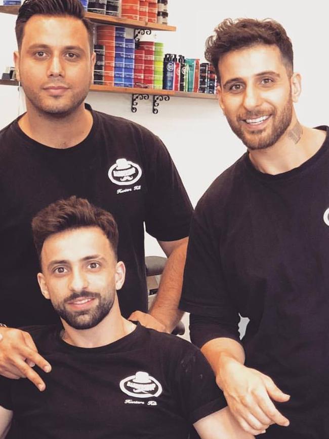 Sam Rahim (right) in his barber shop.