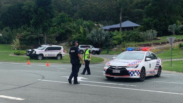 Police man a roadblock at the boundary of the emergency declaration area. Picture: Greg Stolz