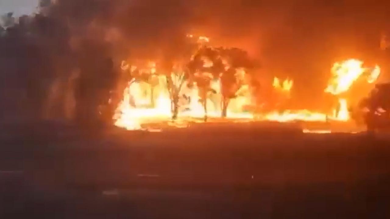 Driving by one of the worst affected areas, a wall of fire and smoke can be seen. Photo: Twitter