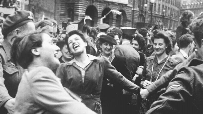 Women join hands on the streets of London to celebrate VE Day marking end of World War II.