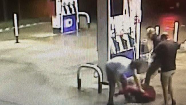 The security footage shows the man, 42, vainly trying to fight off the trio as they rain down punches and kicks