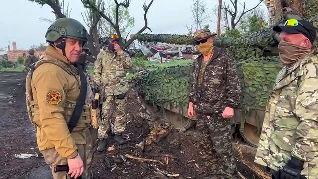 A video grab taken from handout footage posted to Telegram on May 25 shows Yevgeny Prigozhin (left) speaking with members of mercenary force Wagner. Picture: AFP