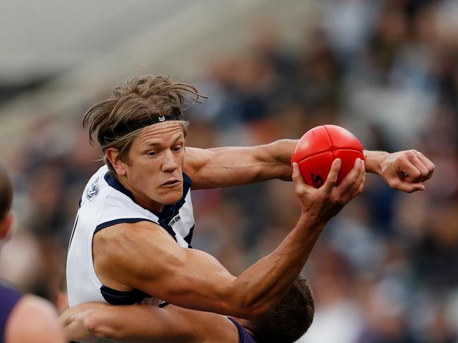 GEELONG, AUSTRALIA – APRIL 30: Rhys Stanley of the Cats is tackled by Darcy Tucker of the Dockers during the 2022 AFL Round 07 match between the Geelong Cats and the Fremantle Dockers at GMHBA Stadium on April 30, 2022 in Geelong, Australia. (Photo by Dylan Burns/AFL Photos via Getty Images)