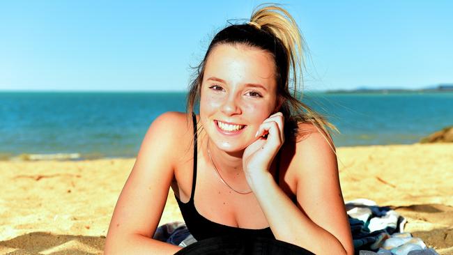 Mia Healey 14, on holidays from Moama, NSW, sunbakes on the Strand, Townsville.