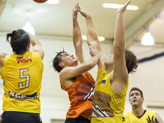 David Werth (centre) competes for possession for Westridge Fruit and Veg Warriors against Southern Cross Bricklaying Eels. Picture: Kevin Farmer