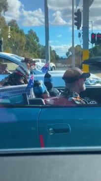 Cool Aussie man and dog ride in matching outfits