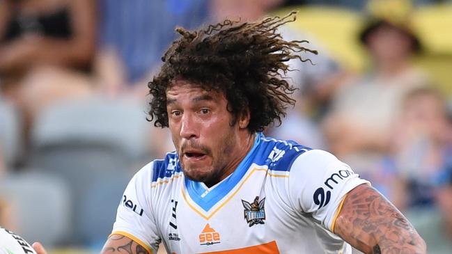 North Queensland Cowboys against Gold Coast Titans at Queensland Country Bank Stadium. Titans' Kevin Proctor gets pass away despite Cowboys' Valentine Holmes. Picture: Evan Morgan