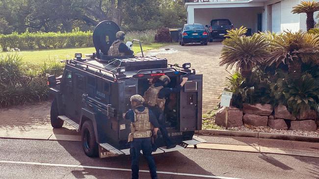 Heavily-armed police officers swarmed on a Cullen Bay Crescent home where they arrested a 53-year-old man over alleged serious harm offences. Picture: Supplied