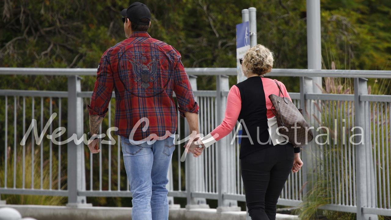 War hero Ben Roberts-Smith holds hands in Brisbane in August last year with Monica Allen, a solicitor on his court case team. Picture: WP Media
