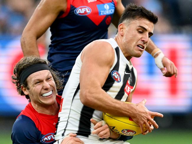 MELBOURNE, AUSTRALIA - JUNE 09: Nick Daicos of the Magpies is tackled by Ed Langdon of the Demons during the round 13 AFL match between Melbourne Demons and Collingwood Magpies at Melbourne Cricket Ground, on June 09, 2025, in Melbourne, Australia. (Photo by Quinn Rooney/Getty Images)