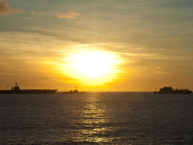 The sun rises over the aircraft carrier USS George Washington, the guided-missile destroyer USS McCampbell and the fleet replenishment oiler USNS Walter S. Diehl during a recent foray into the South China Sea. Picture: US Navy