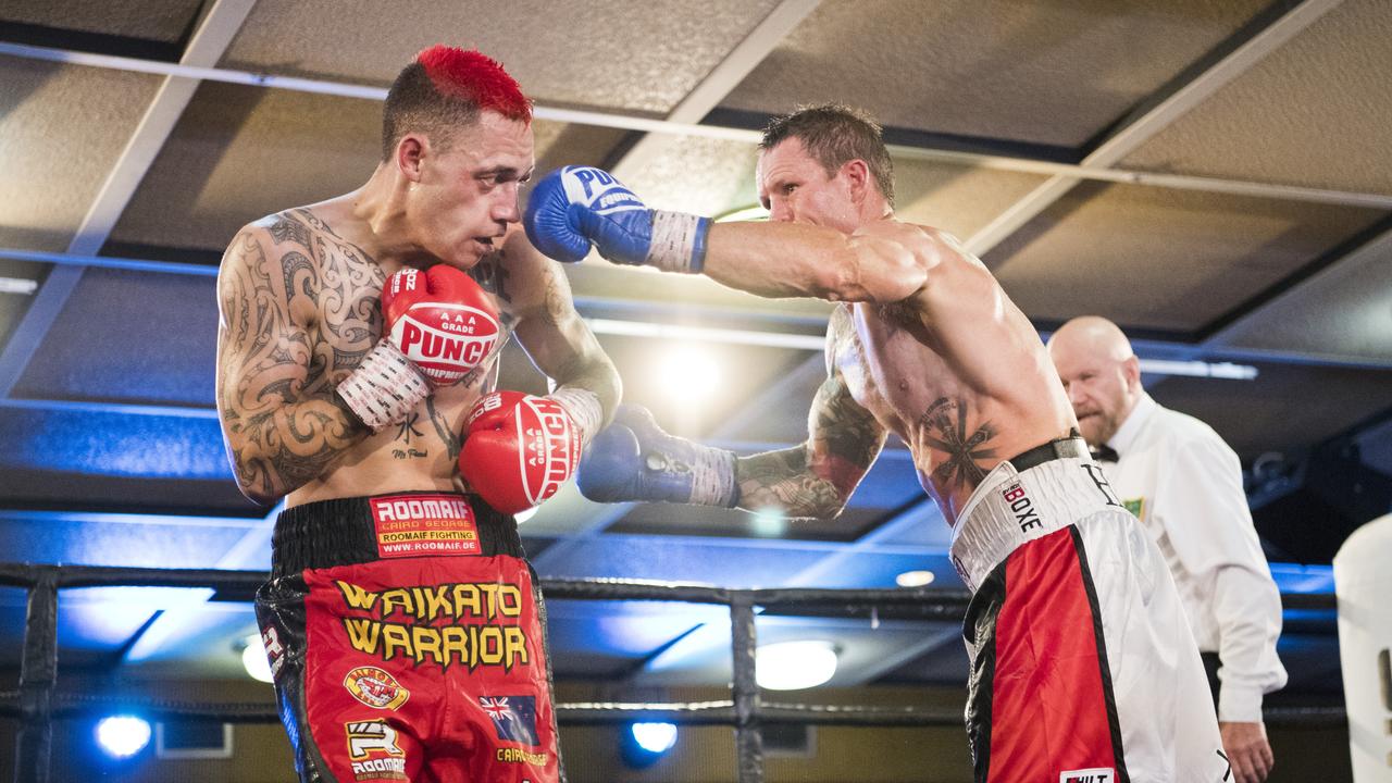 Jamie Hilt ( right ) takes the WBU World Super Lightweight in the fight against Cairo George. Picture: Nev Madsen. Saturday, 2nd Nov, 2019.