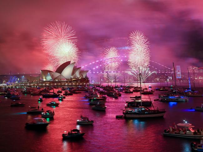 The "family fireworks", displayed three hours before midnight every year ahead of the main show at midnight, fill the sky over the Opera House and Sydney Harbour Bridge in Sydney. Picture: Izhar Khan/Getty Images