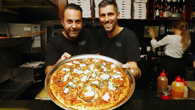 TASSIE LIVING Five of the best pizzas.  Cugini in Bellerive.  (L-R) Marco Giusti and Alfonso Giusti are co-owners of the restaurant and are pictured with a family size Caponata pizza - eggplant, capsicum, fresh tomato, onion, ricotta, basil, garlic and cheese - $25Picture: MATT THOMPSON