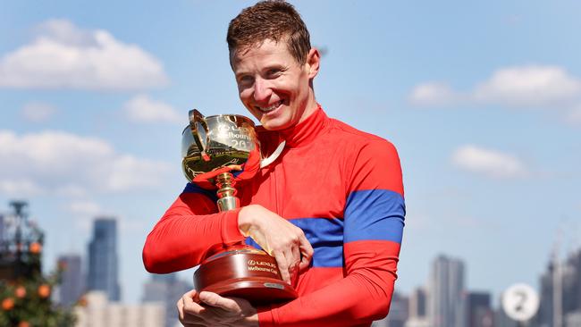 James McDonald with the Melbourne Cup trophy. Picture: Michael Klein