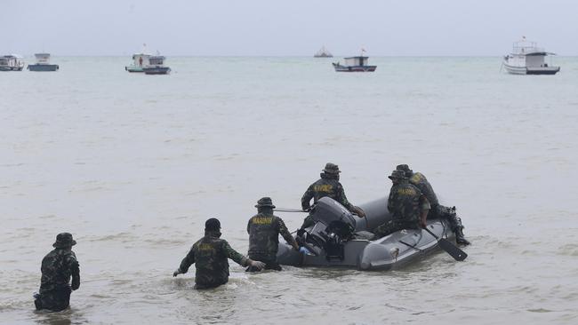 Indonesian marines search for the tsunami victims at a beach in Sumur, Java, yesterday. Picture: AP