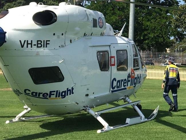 A CareFlight helicopter landed in St Leonard's Park, North Sydney, to treat a man seriously injured in a motorcycle incident on the Warringah Freeway. Picture: CareFlight