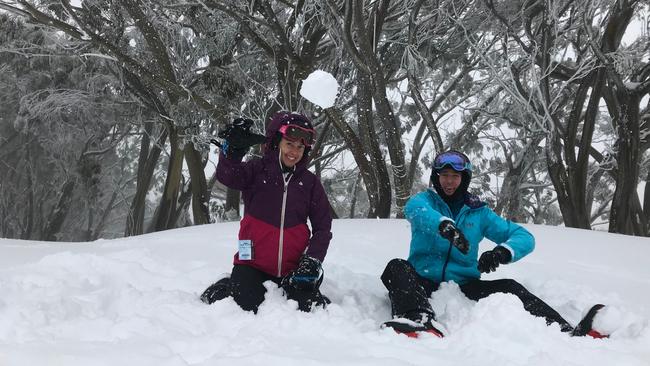 Friends Sarah Fisher and Harry Waters from Richmond enjoy record snow falls at Mt Baw Baw.